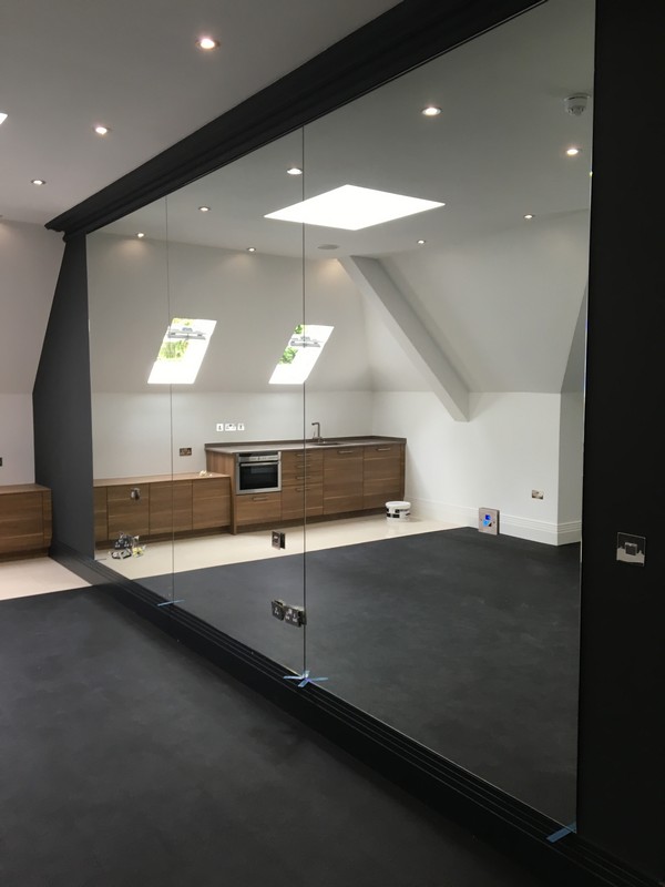 Frameless glass partition in loft conversion by Balham glaziers