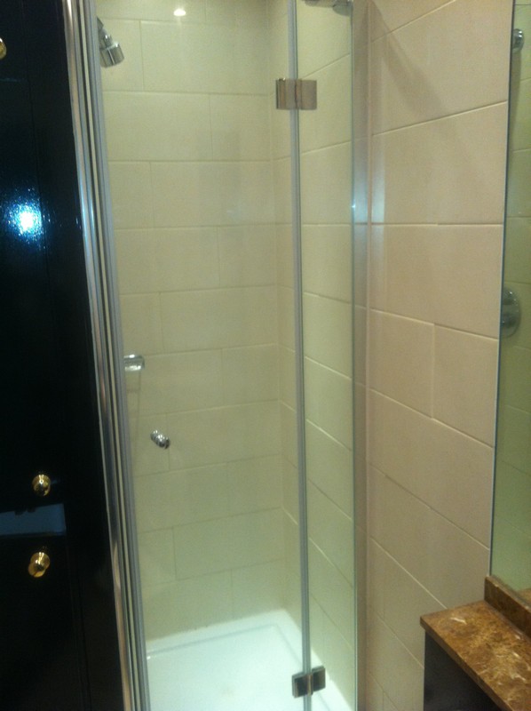 Frameless glass shower enclosure with chrome fittings in Balham