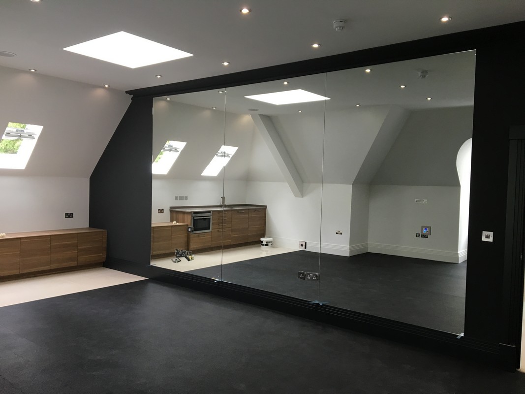 Frameless glass wall dividing loft conversion in Balham