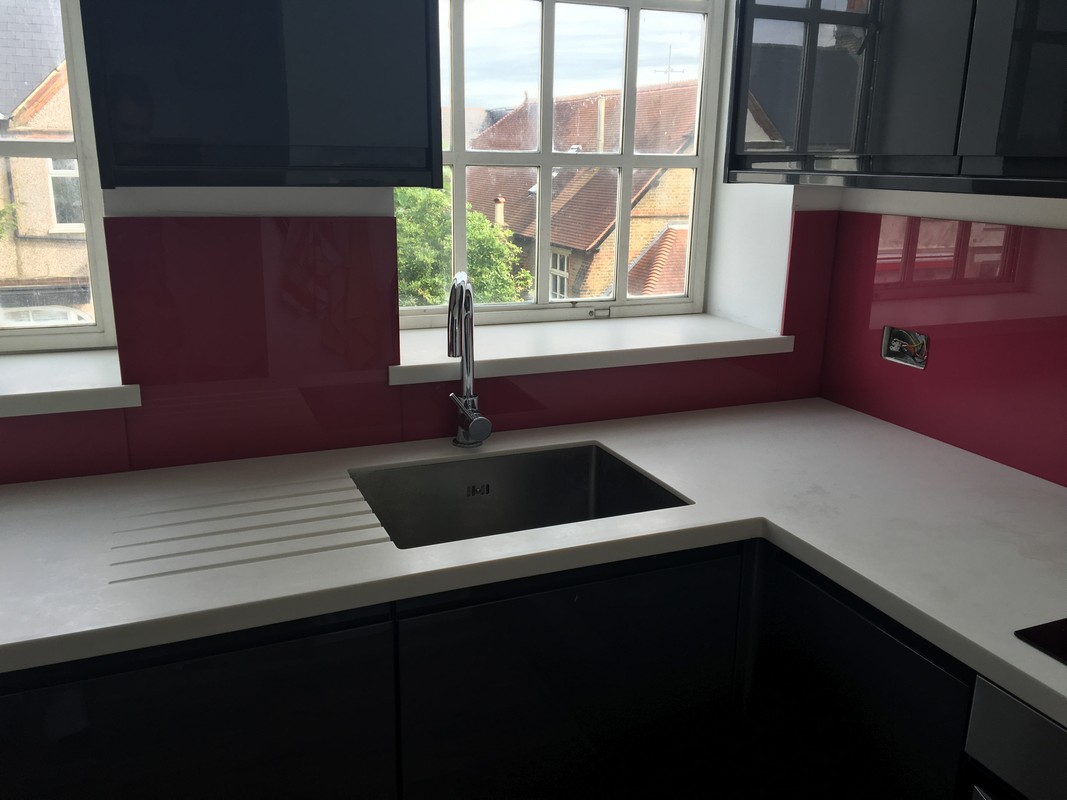 Deep plum coloured glass splashback in modern Balham kitchen