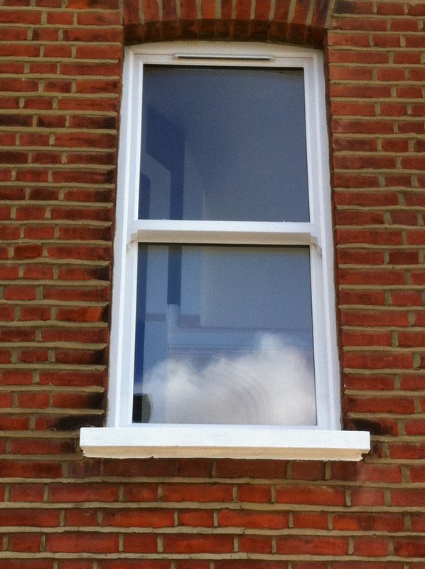 uPVC sash window on Victorian red brick house in Balham